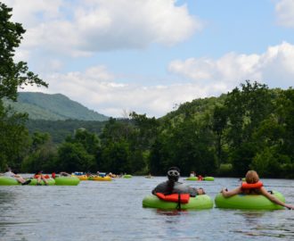several tubers relaxing on the calm waters Downriver Canoe Company Shenandoah Valley River
